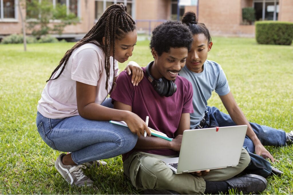 3 College students looking at a computer